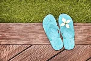A pair of flip-flops on a backyard deck