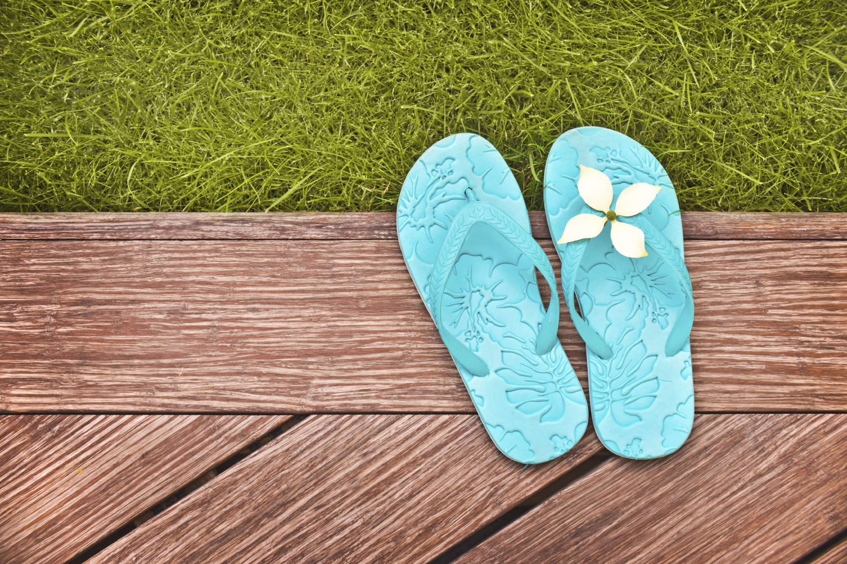 A pair of flip-flops on a backyard deck